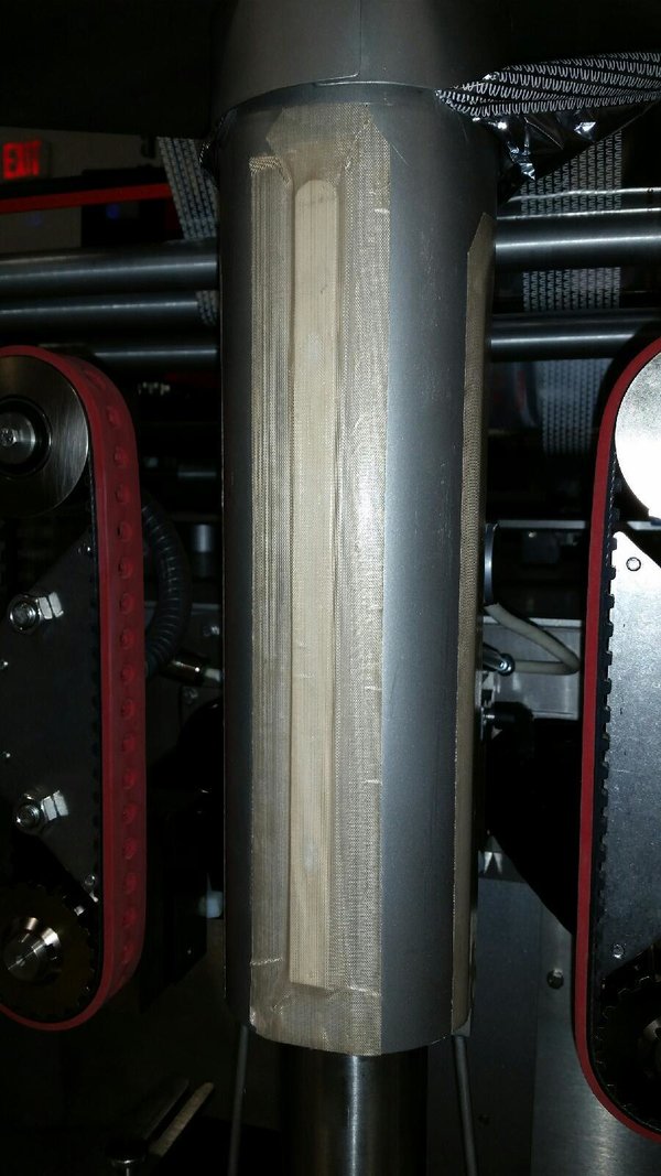 Worn_teflon_tape_behind_film_on_forming_tube_Vertical_Form_Fill_Seal_Bagger